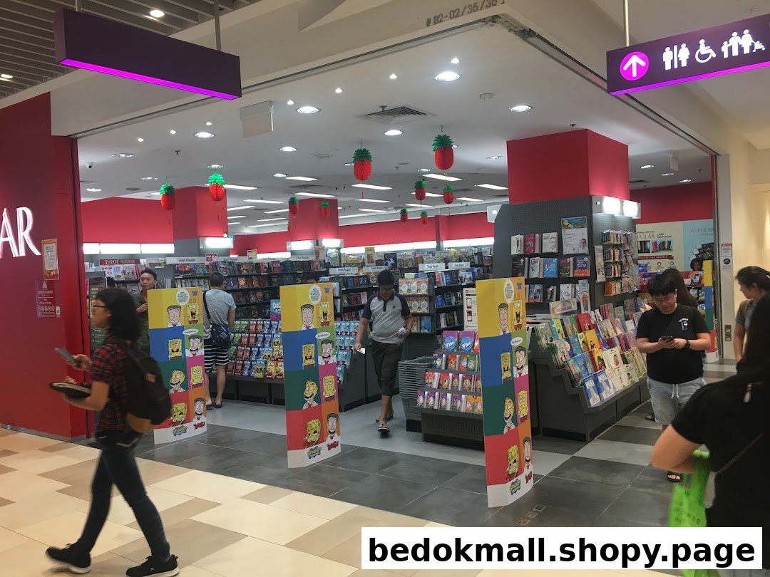 Entrance of a bookstore with people browsing books and merchandise.
