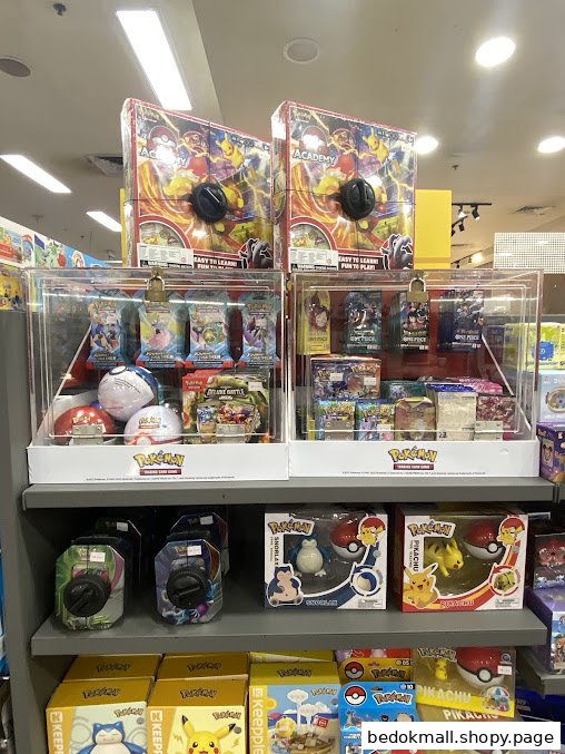 Shelves inside a shop displaying various Pokémon merchandise and trading cards.