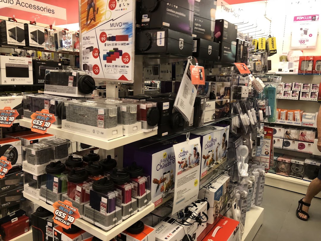 Interior view of a retail store displaying electronics and accessories on shelves.