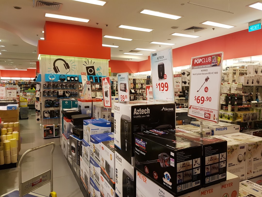 Interior view of a retail store with electronics, appliances, and promotional displays.
