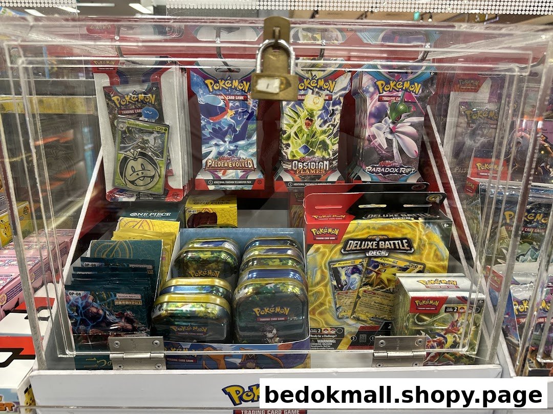 A locked display case filled with various Pokémon trading card game products.