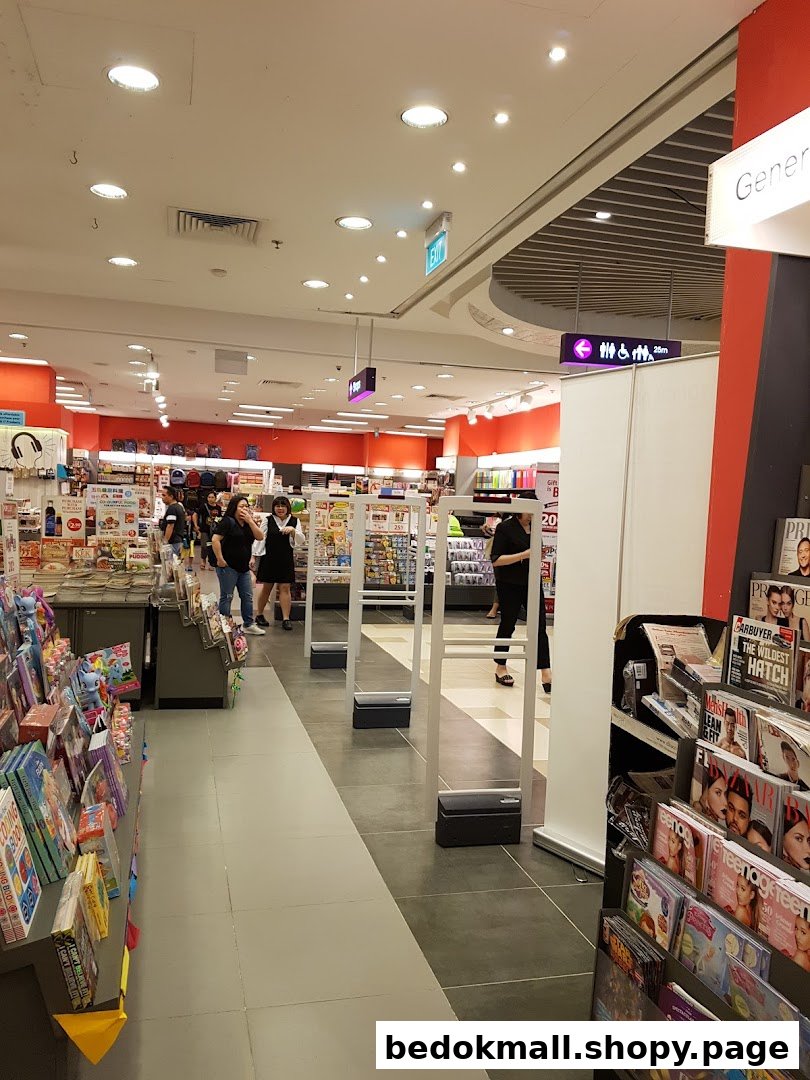 Interior view of a bookstore with shelves, people, and security gates.