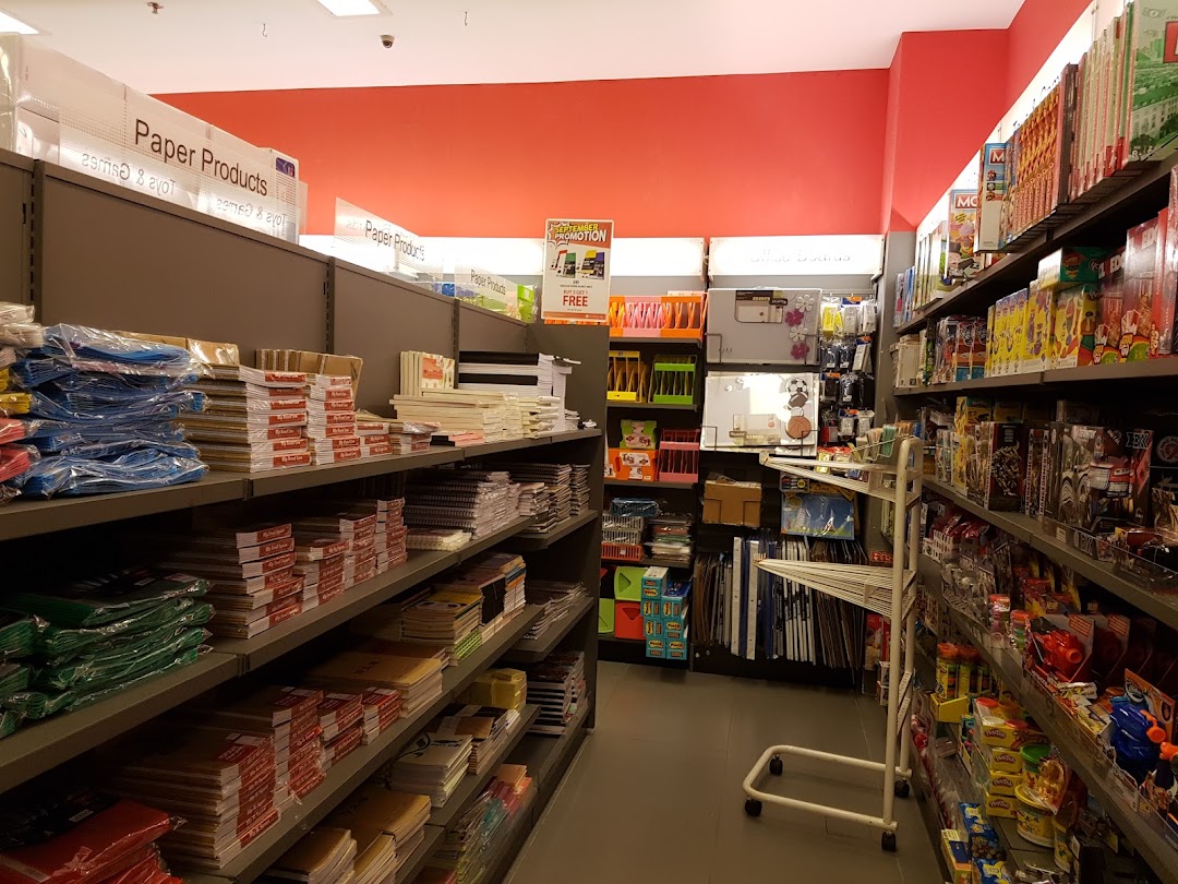 Interior view of a bookstore aisle with shelves full of paper products and books.