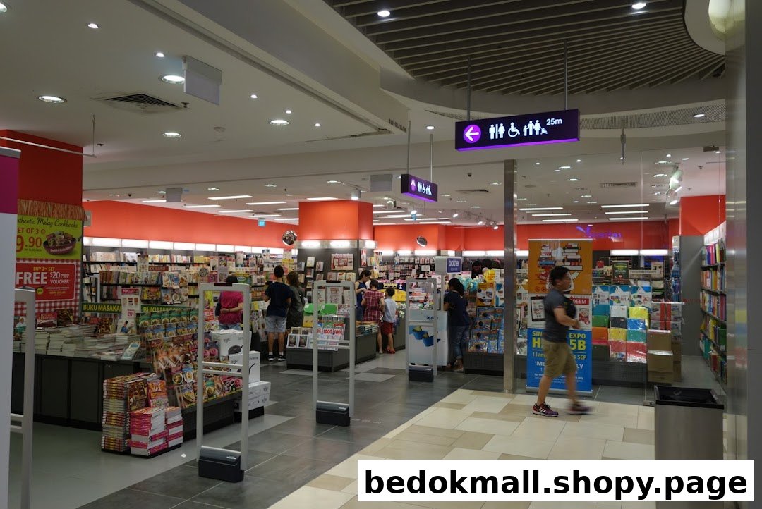 Interior of a bookstore with customers browsing books and promotional displays.
