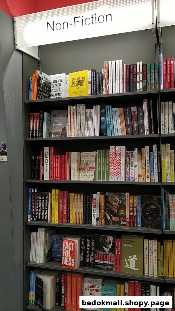 A bookshelf filled with non-fiction books in a bookstore.