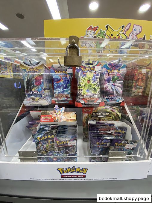 A locked display case filled with various Pokémon Trading Card Game products.