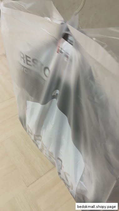 Garment in a clear plastic dry cleaning bag with 'Presto' logo visible.