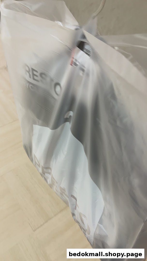 A plastic bag with dry-cleaned items and the Presto logo.