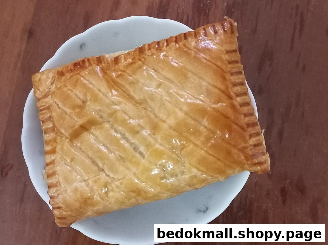 A golden-brown rectangular pastry on a white plate, viewed from above.