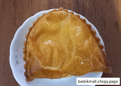 A golden-brown pastry on a white plate.