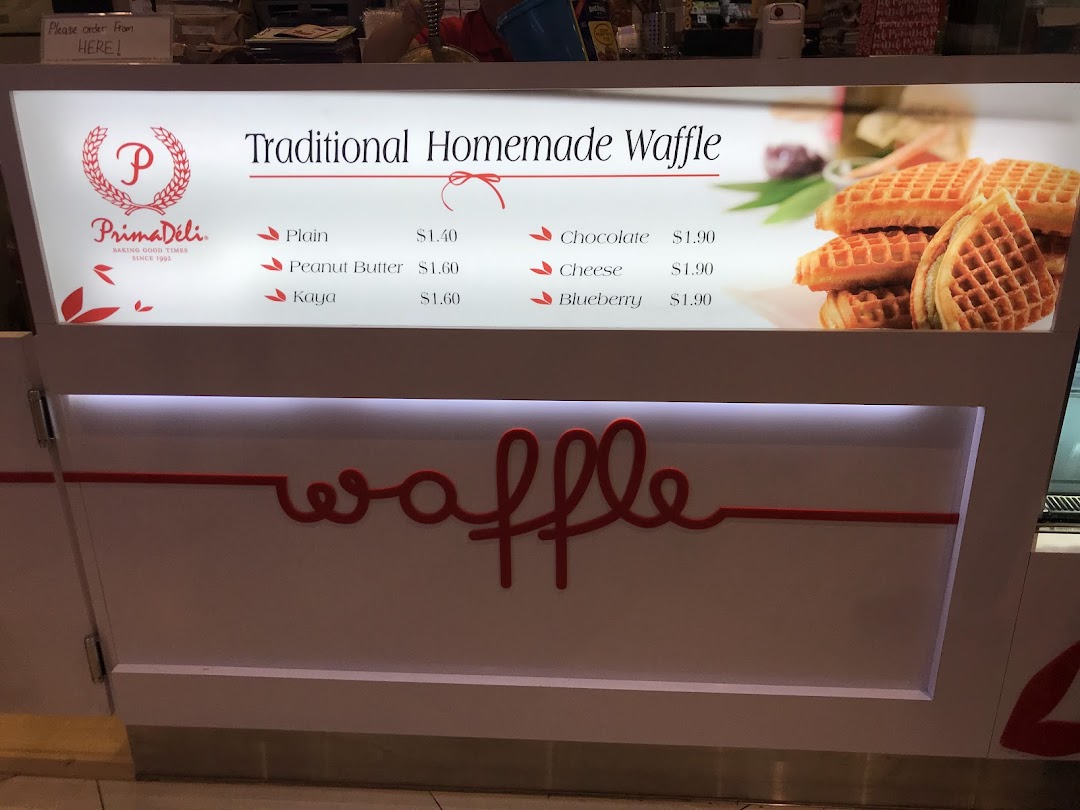 A menu board displaying waffle flavors, prices, and an image of waffles.