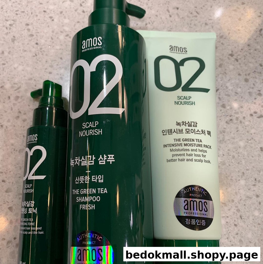 Close-up of three green Amos Professional hair care products.