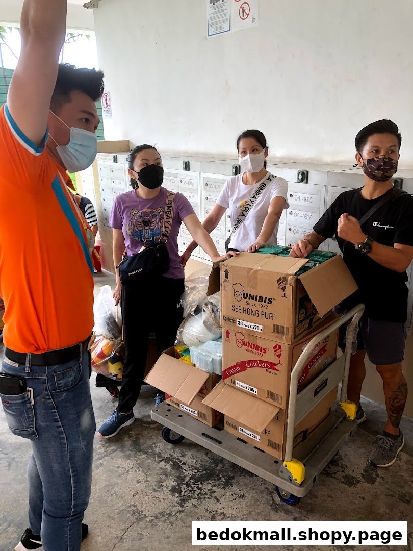 People in masks with a cart full of boxes near mailboxes.