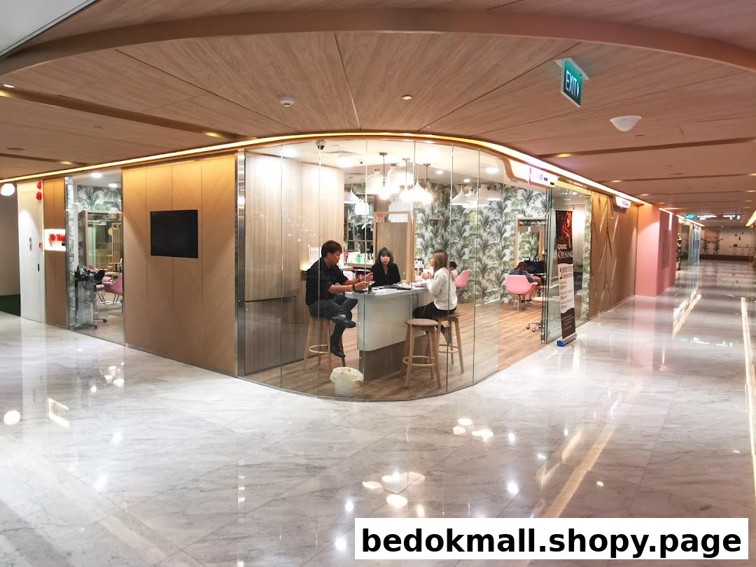 Interior view of a hair salon/nail bar with glass walls in a mall corridor.
