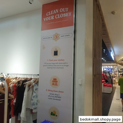 Interior view of a shop with a large sign detailing clothes upcycling steps.