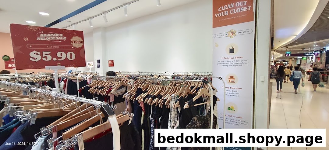 Interior view of a clothing shop with sale items and an upcycling banner.