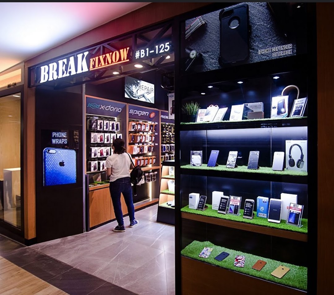 Shop entrance with displays of phone accessories and a customer inside.