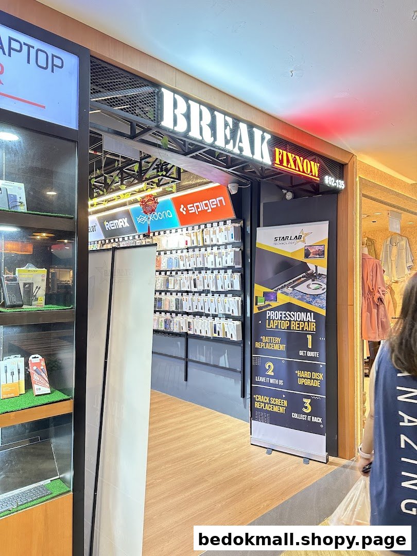 Entrance of a tech repair shop with display cases and repair services banner.