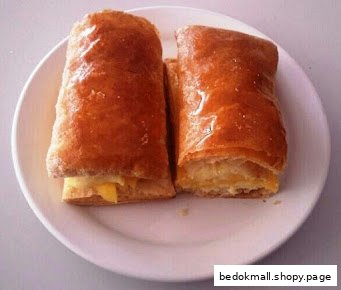 Two golden-brown pastries with filling on a white plate.