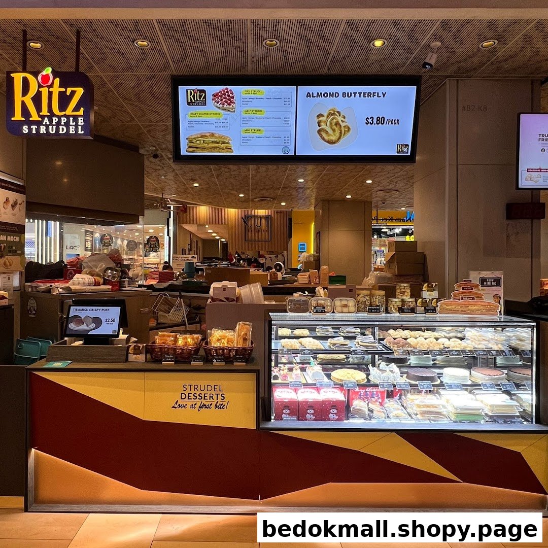 Interior view of a dessert shop counter with display case and menu board.