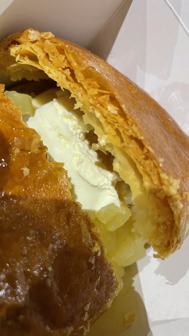 Close-up of apple strudel with cream and apple filling.