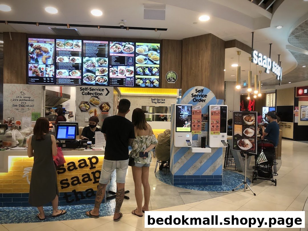 Interior view of a Thai food counter with customers and large menu boards.