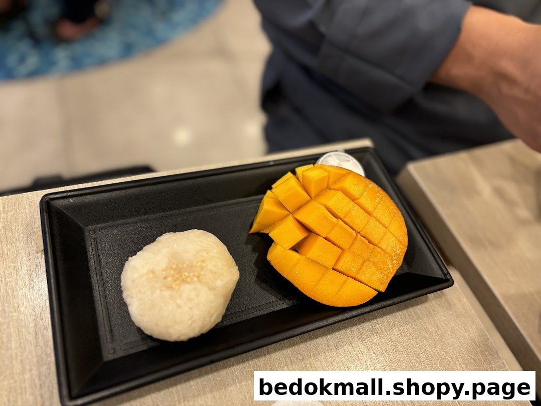 Close-up of mango sticky rice served on a black plate.