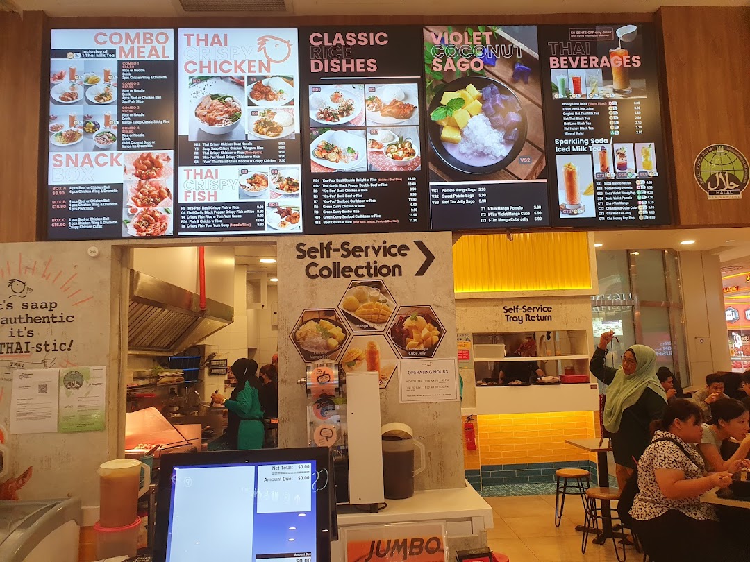 Large menu board above a busy Thai restaurant kitchen and dining area.