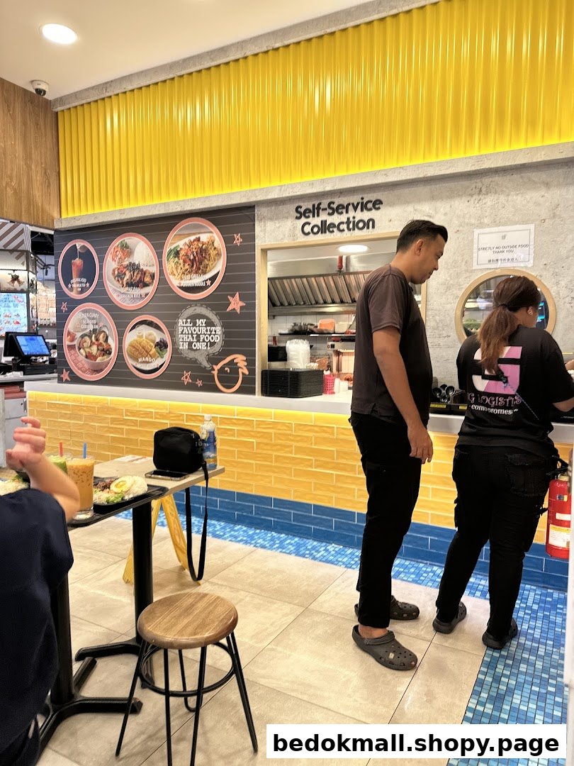 Interior view of a Thai restaurant with customers and a self-service counter.
