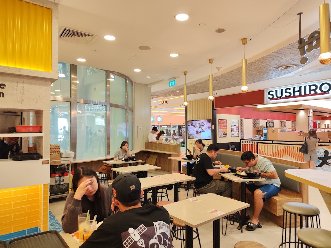Interior view of a restaurant with customers dining at tables.