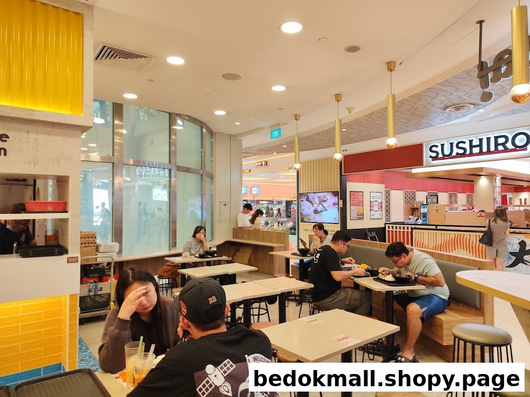 Interior view of a restaurant with customers dining at tables.