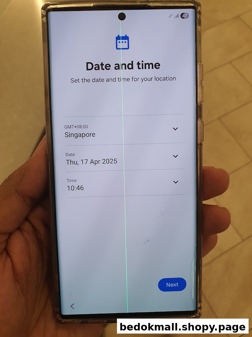 Hand holding a smartphone displaying date and time settings with a green line.