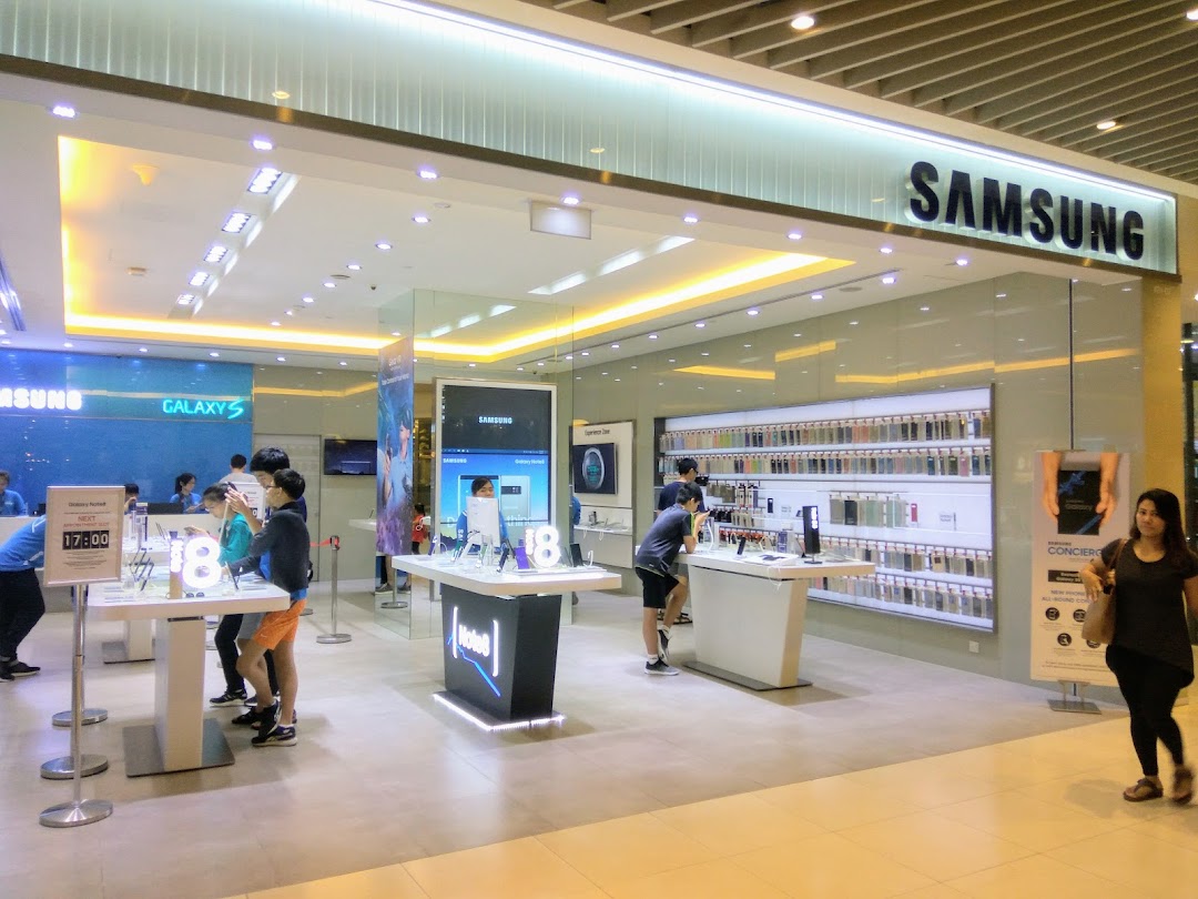 Samsung Experience Store entrance with customers browsing products and displays.