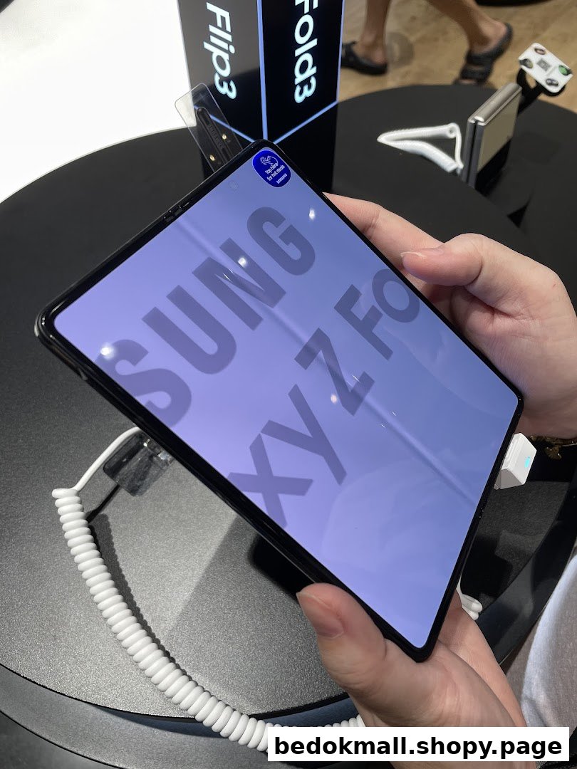 Person holding a Samsung Galaxy Z Fold phone in a retail store.