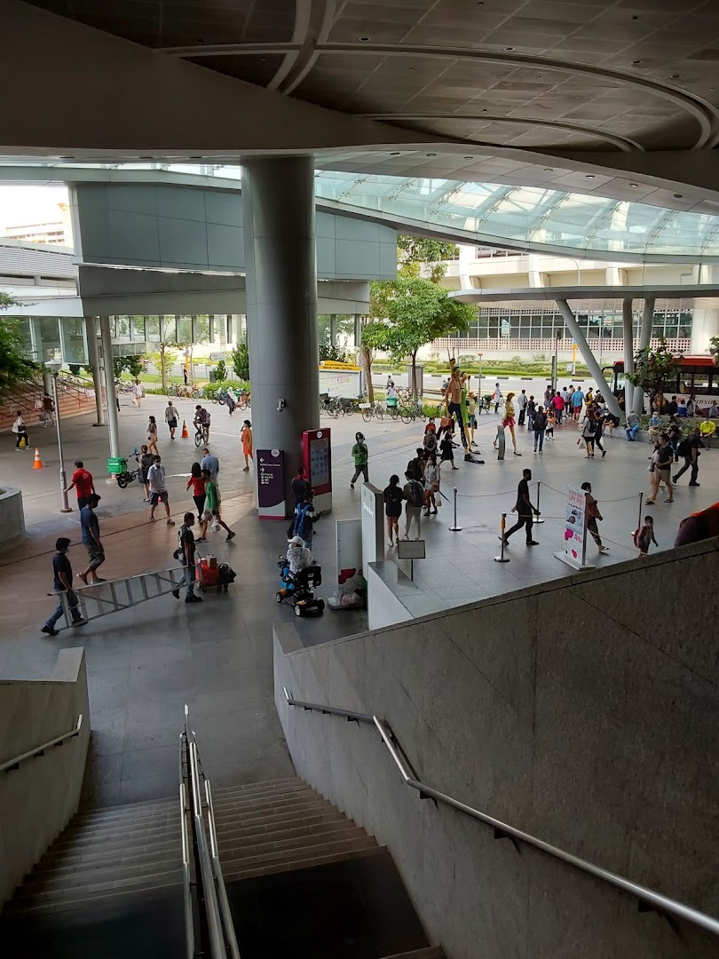 Large modern public space with many people and architectural structures.