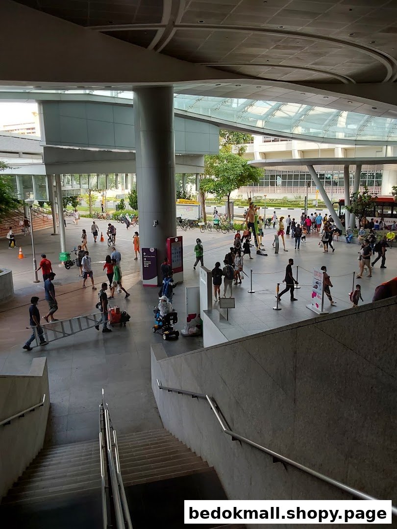 Large modern public space with many people and architectural structures.