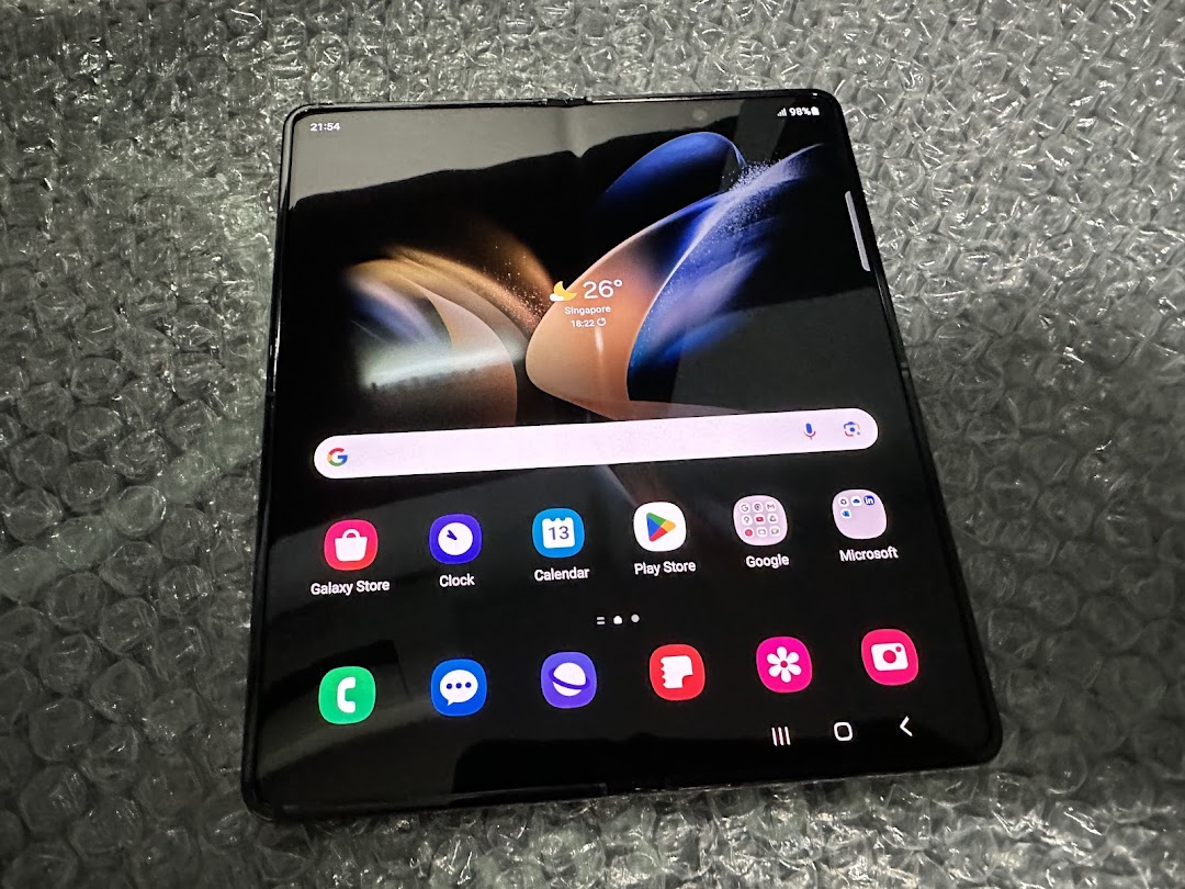 A Samsung foldable phone displaying its home screen on bubble wrap.