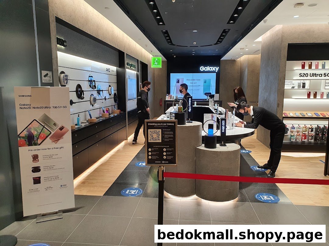 Interior view of a Samsung Experience Store with products, staff, and customers.