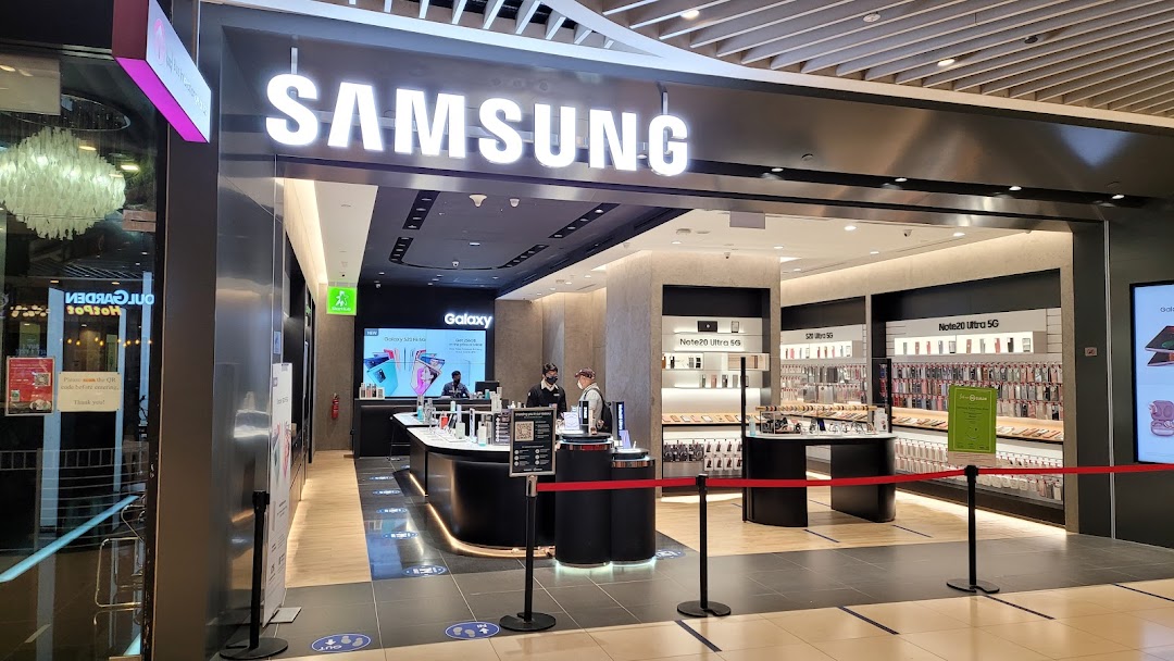 Entrance of a Samsung Experience Store with its illuminated sign and interior visible.