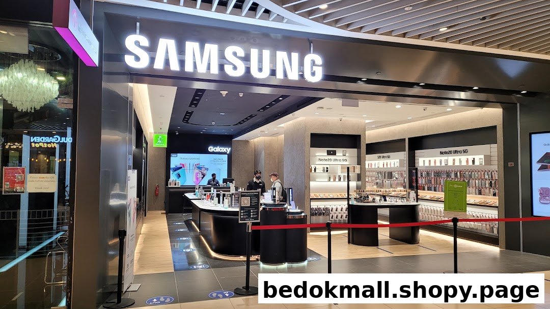 Entrance of a Samsung Experience Store with its illuminated sign and interior visible.