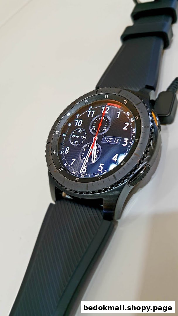Close-up of a black Samsung smartwatch with a digital display.