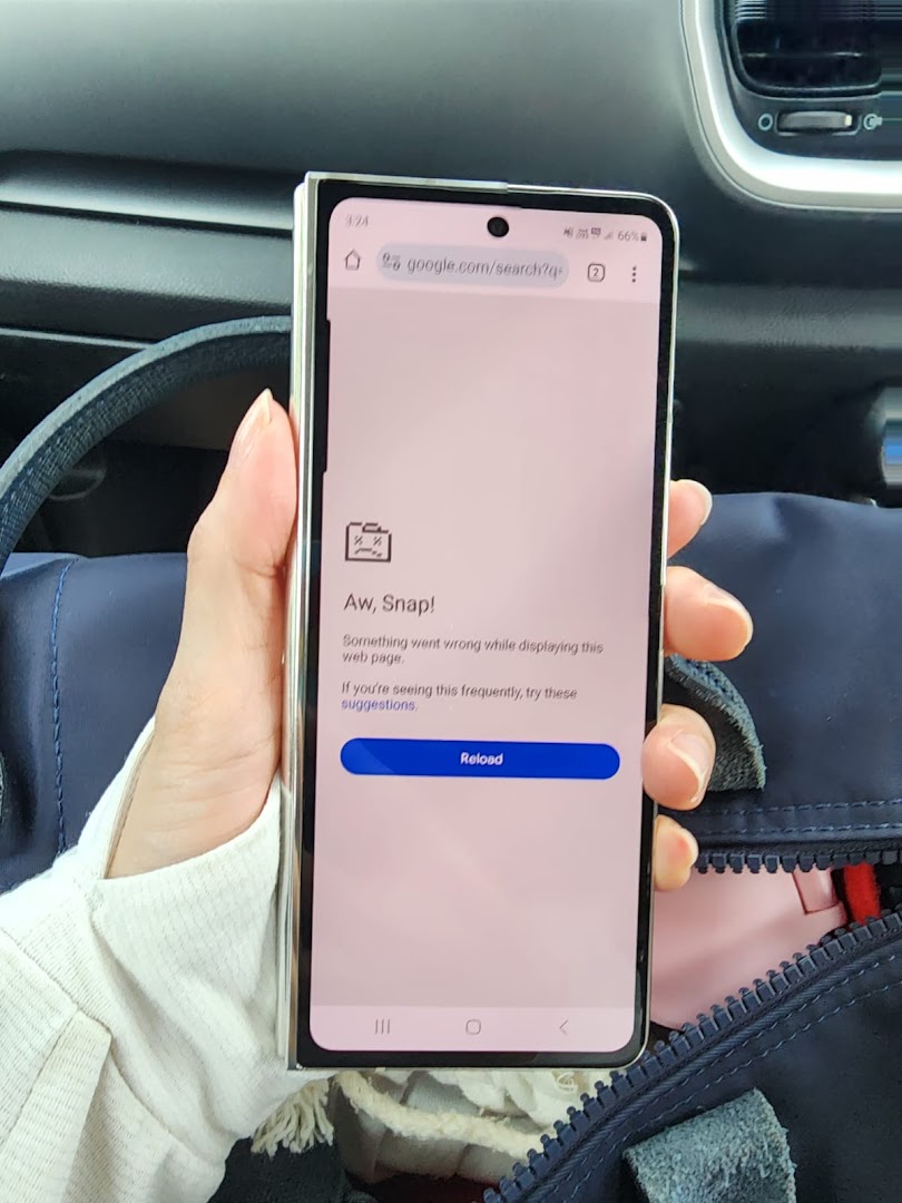 A hand holds a smartphone displaying a web page error message.