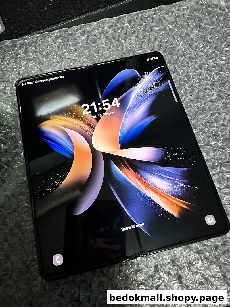 A Samsung foldable phone displaying its lock screen on a textured surface.