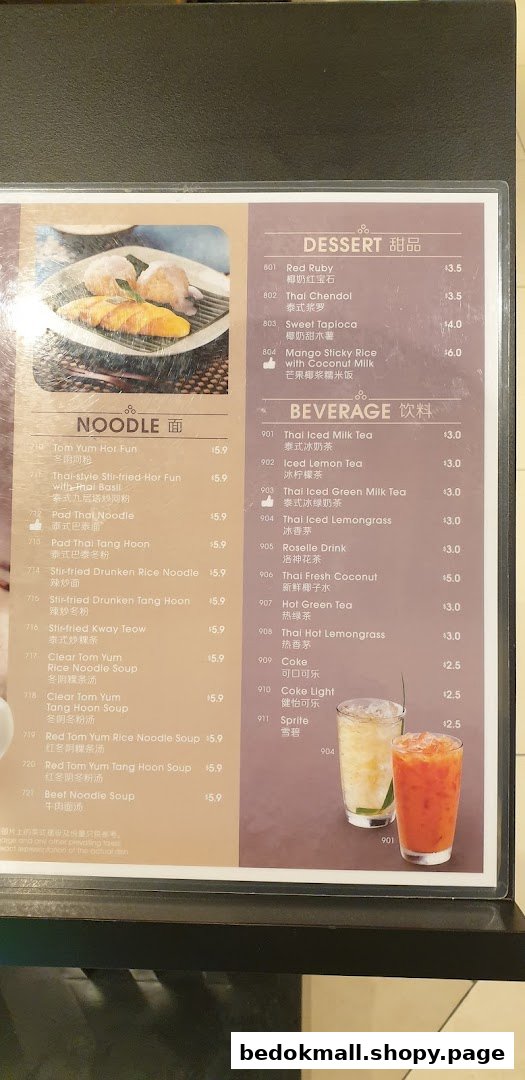 A detailed menu board displaying noodle dishes, desserts, and beverages with prices.