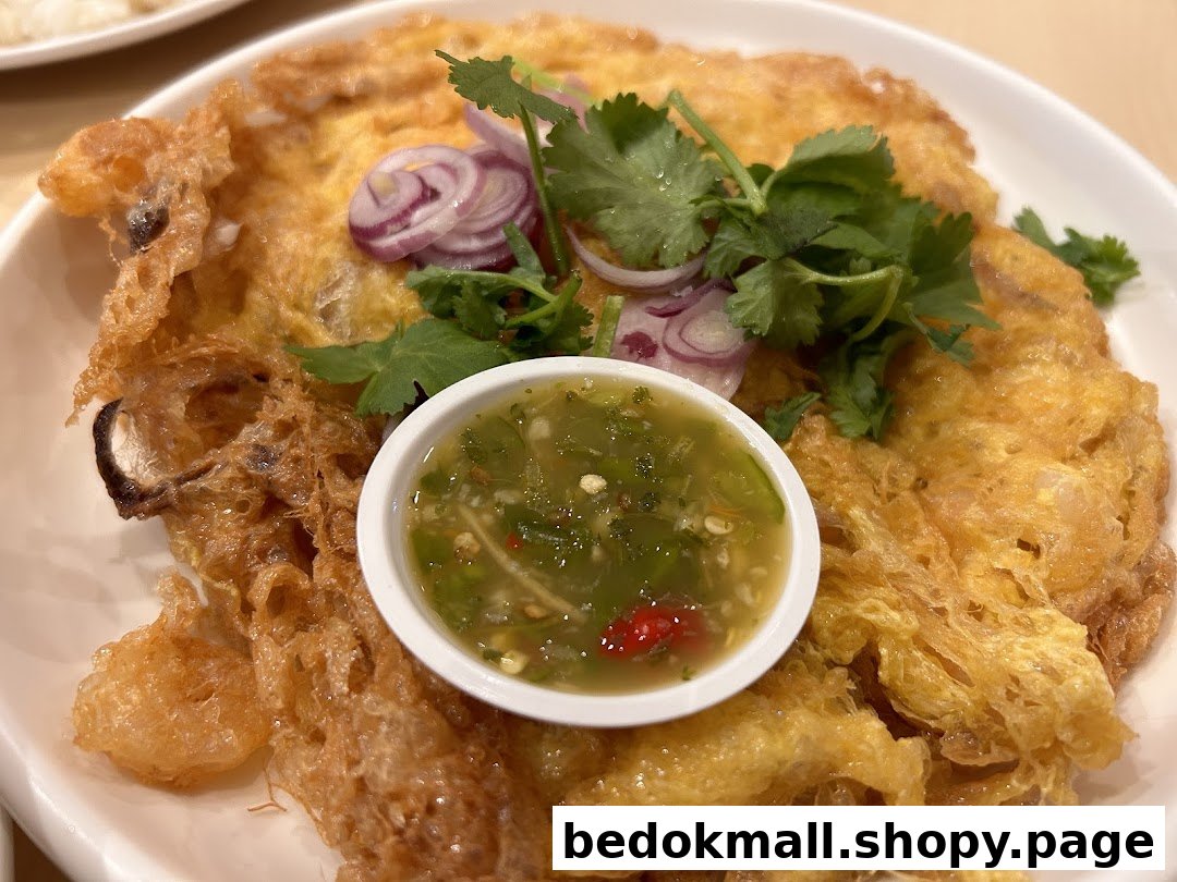 Close-up of a fried omelet dish with herbs, red onions, and dipping sauce.