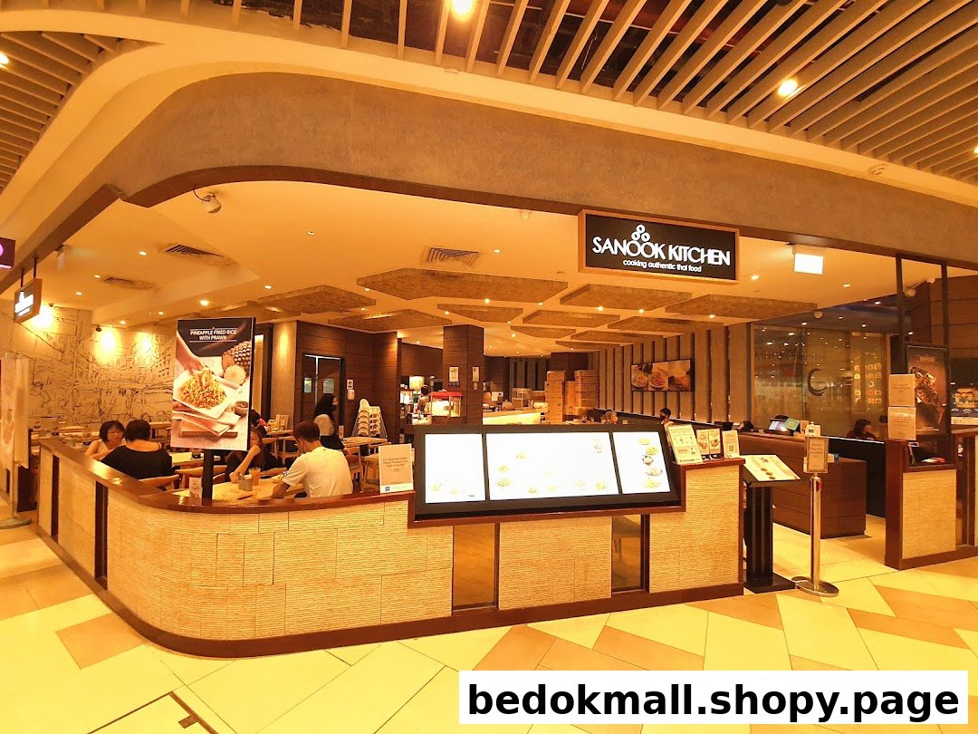 Interior view of Sanook Kitchen restaurant with customers dining and a service counter.