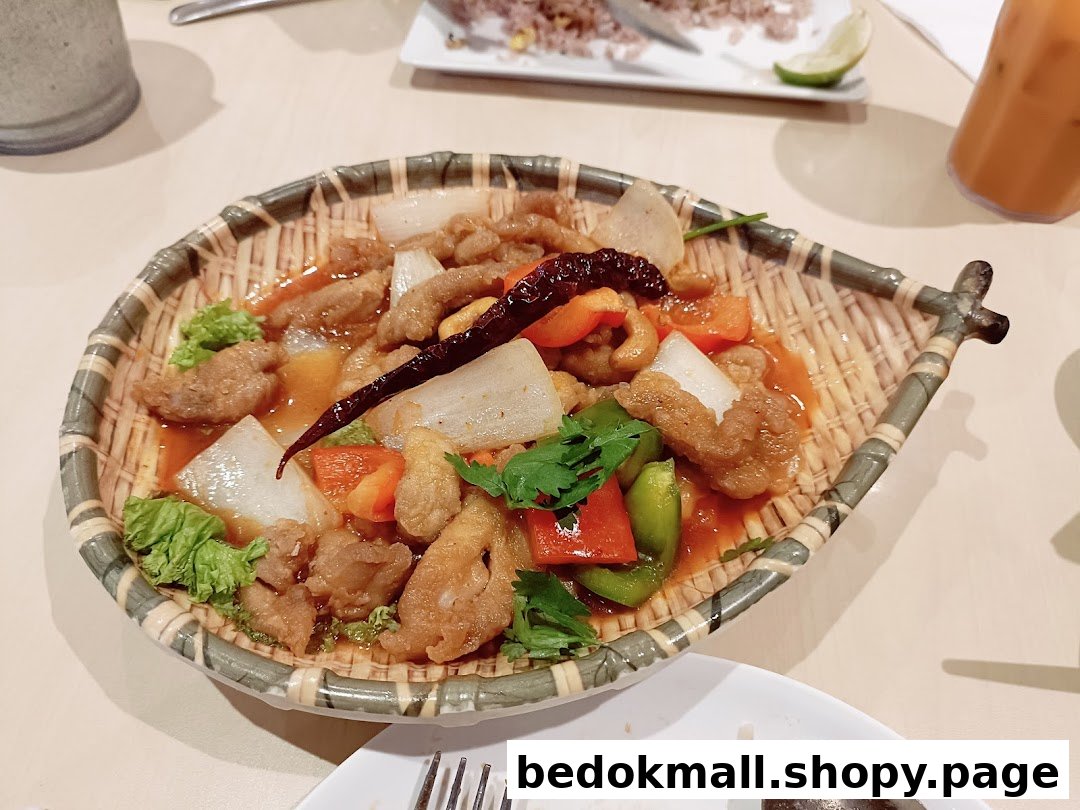 A dish of sweet and sour chicken with vegetables on a woven plate.