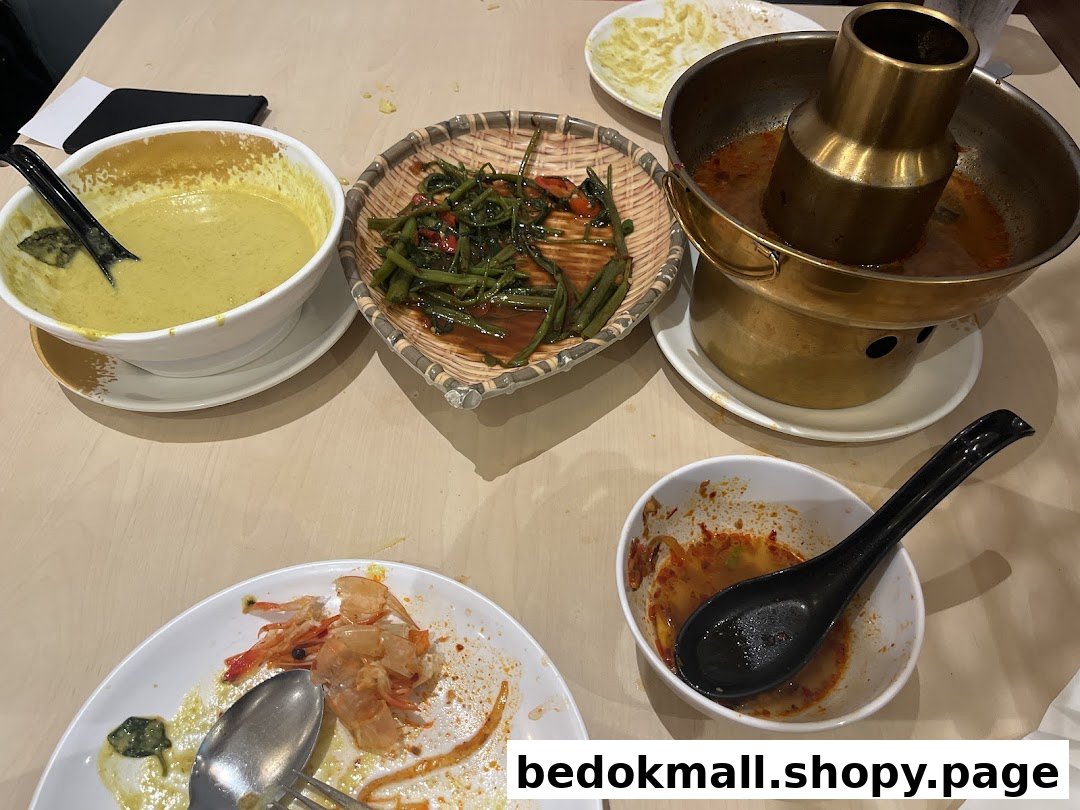 Table with various Thai dishes, including hot pot, curry, and eaten shrimp.
