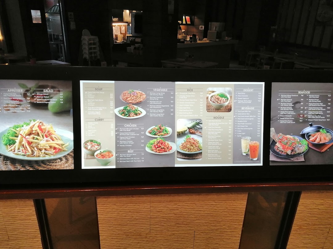 A digital menu board showcasing a wide variety of Thai dishes, drinks, and desserts.