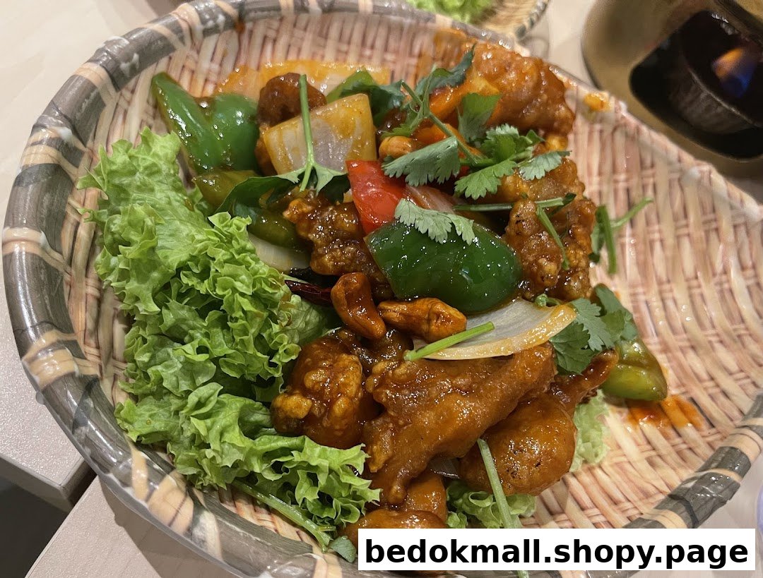 A dish of stir-fried chicken with vegetables and cashews in a woven basket.